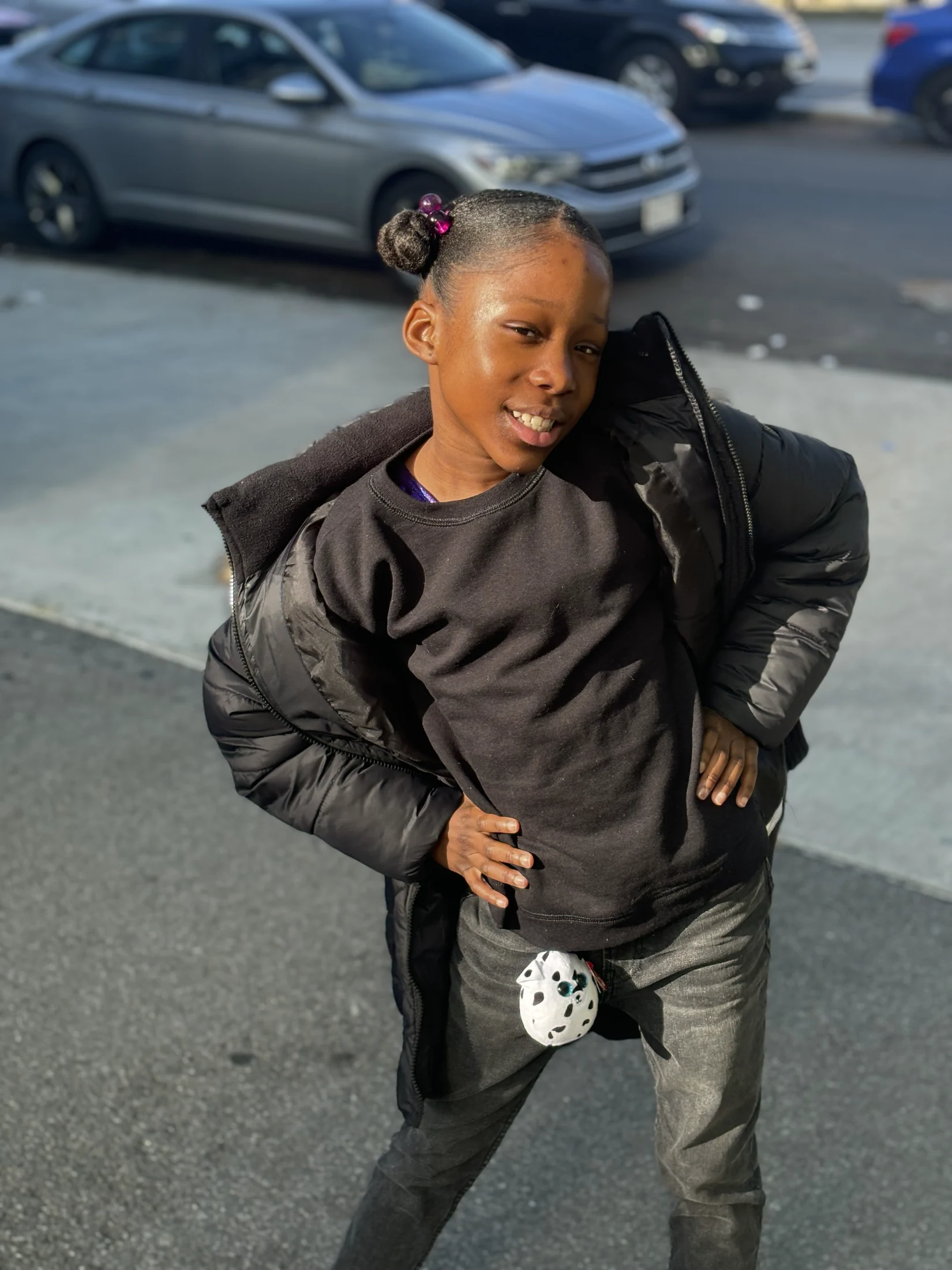 Avi posing confidently in a black jacket outdoors